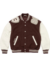 Brown Supreme Captain varsity jacket with cream sleeves and varsity shoulder patches