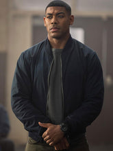 Aaron Pierre Lanterns navy bomber jacket front view indoor scene
