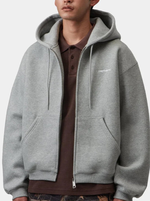 Grey fleece zip hoodie worn open over polo shirt, model front close-up with chest logo