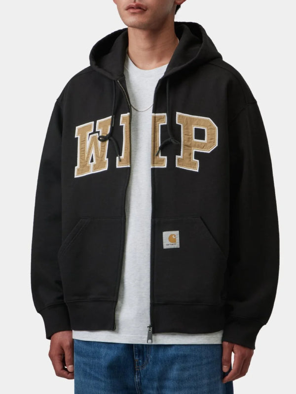 Black zip hoodie worn with WIP chest patch, model front view hands in pockets