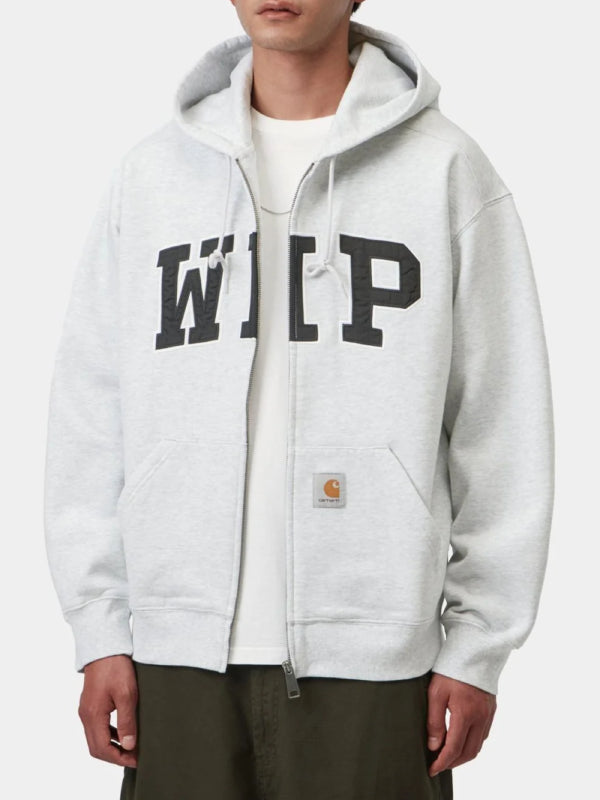 Grey zip hoodie worn with WIP chest patch, model front view hands in pockets