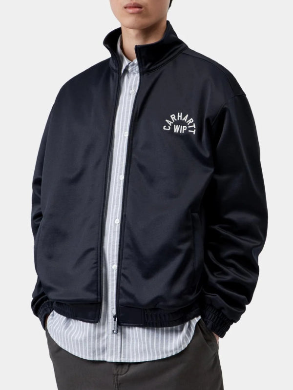 Carhartt WIP fleece jacket worn with hands in pockets, navy colorway front view