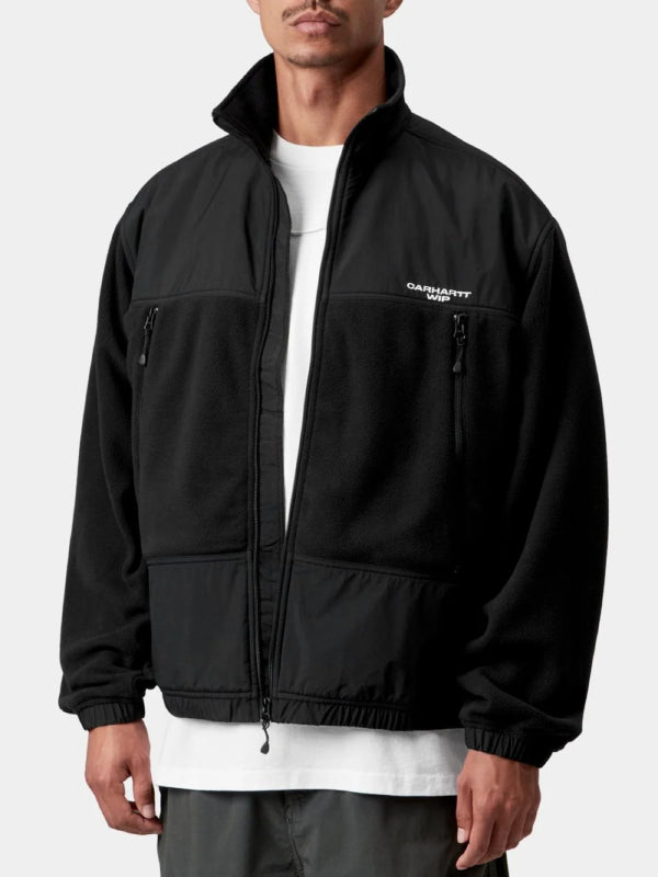 Black fleece jacket worn open over white tee, model front view with chest logo