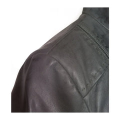 Close-up of dark grey biker jacket shoulder with textured leather detail
