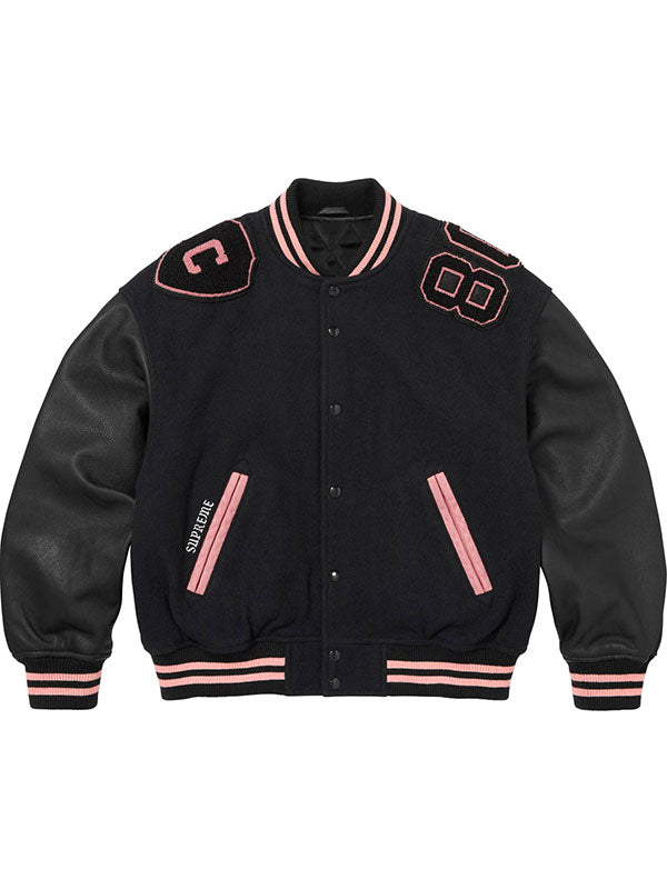 Black Supreme Captain varsity jacket with pink striped ribbing and leather-style sleeves front view