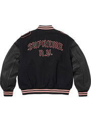 Black Supreme Captain varsity jacket back view with pink SUPREME N.Y. lettering