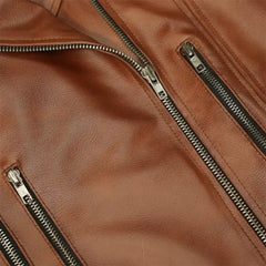 Close-up of brown leather biker jacket with silver zippers and textured material