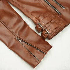 Close-up of women's brown biker jacket sleeves with zippers and buckle details