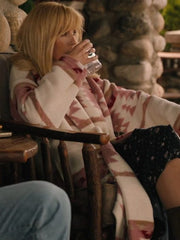 Kelly Reilly Beth Dutton Yellowstone pink printed coat seated scene on porch