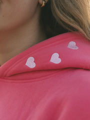 Tiny heart embroidery on pink hood