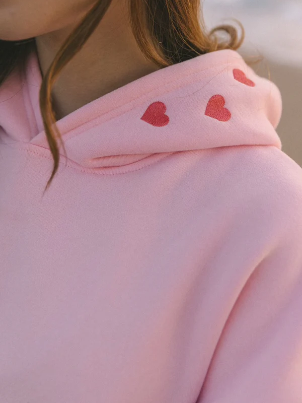Red heart stitching hood close up pink pullover