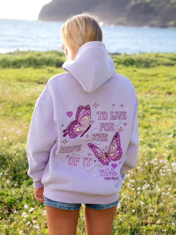 To Live For the Hope of It All lavender hoodie back view ocean background