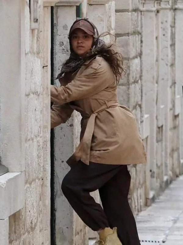 Kiara Carrera Outer Banks trench coat side view alley scene