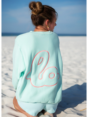 Back detail of Lo Crew mint green sweatshirt showing oversized logo outline