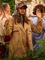 Kiara Carrera Outer Banks Season 5 khaki trench coat hands raised