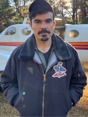 Torres Outer Banks black bomber jacket close up front airplane