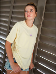 Relaxed fit yellow streetwear tee worn with denim shorts, side angle