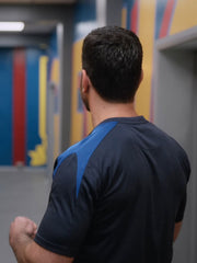 Roy Kent Ted Lasso AFC Richmond navy t-shirt back view hallway Season 4