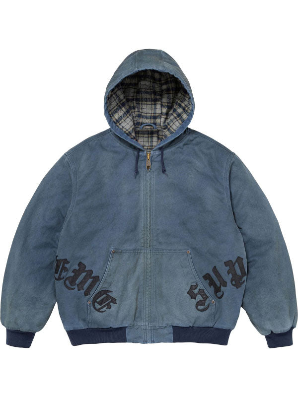 Blue washed cotton hooded jacket shown from the front, featuring plaid lining, zip closure, leather appliqué details and ribbed trim.