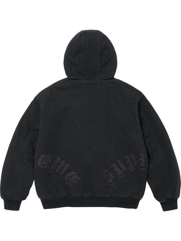 Black washed cotton hooded jacket shown from the back with dark leather appliqué lettering, stitched panels and ribbed hem.