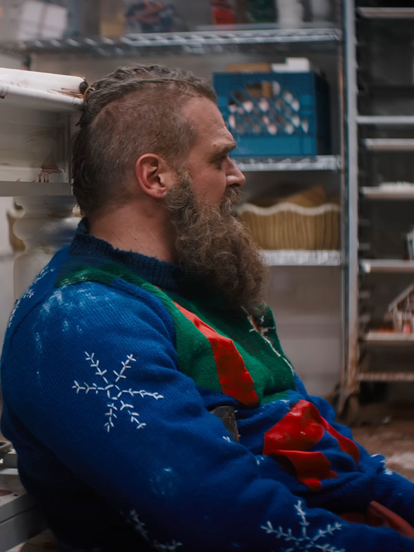 David Harbour Santa Claus sweater side profile snowflake sleeve detail